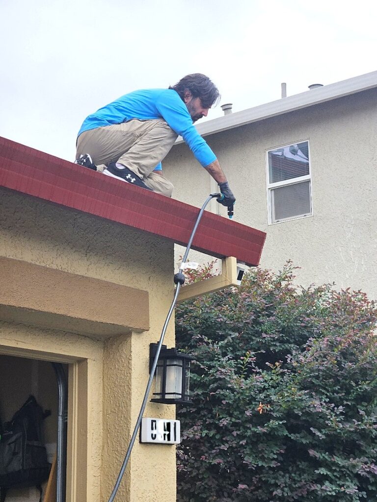 Cleaning a gutter from the roof.