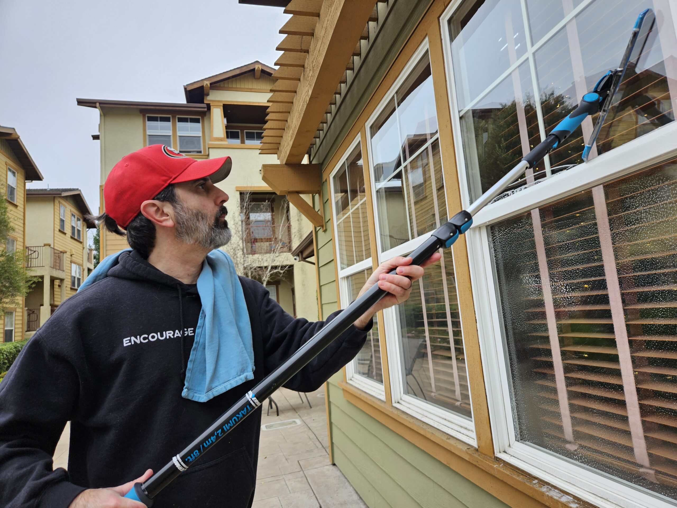 Using squeegee while window cleaning in Fair Oaks