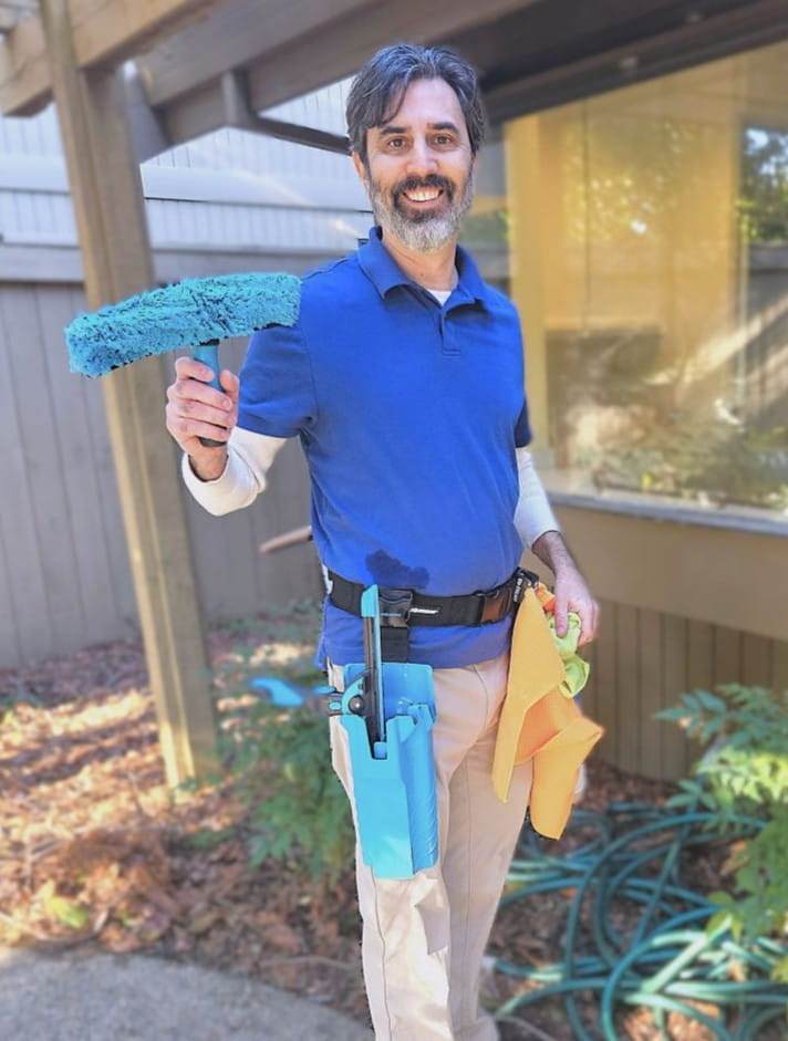 Man holding window cleaning mop.
