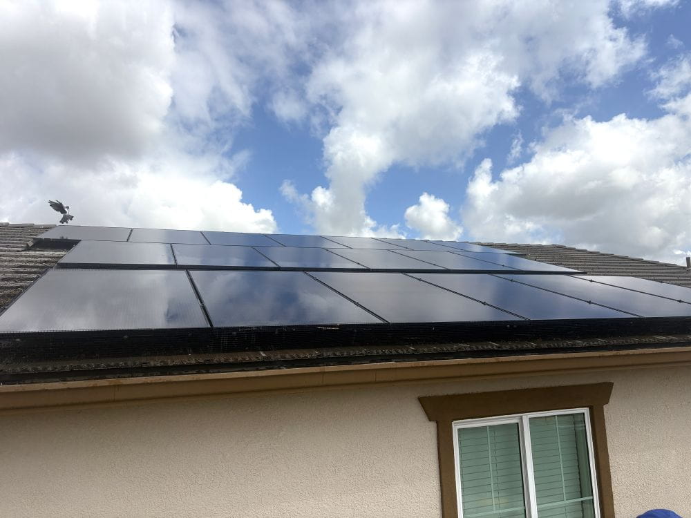 Clean solar panels on the roof of a two story house.
